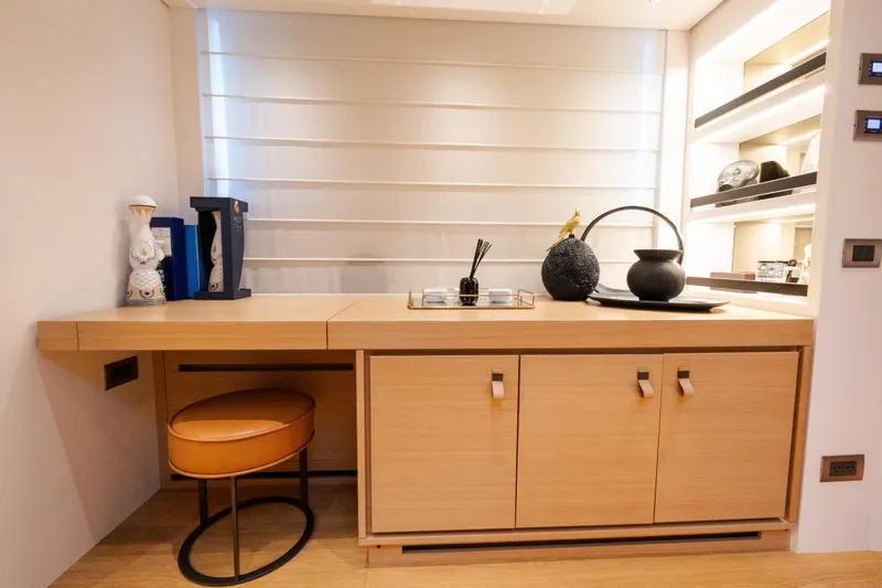 Gatsby Yacht Photos Pics Modern interior of Sanlorenzo SL96 yacht, featuring elegant wooden cabinetry and decorative accents.