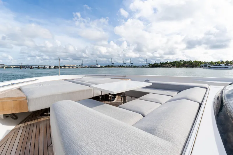 Gatsby Yacht Photos Pics Luxurious Sanlorenzo SL96 yacht deck with elegant seating, overlooking serene waters and blue sky.