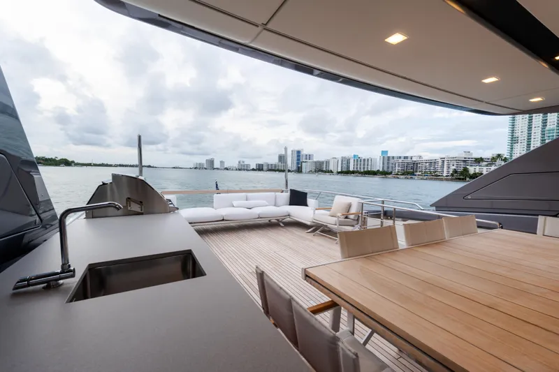 Gatsby Yacht Photos Pics Luxurious 2021 Sanlorenzo SL96 yacht deck with seating, dining area, and ocean view.
