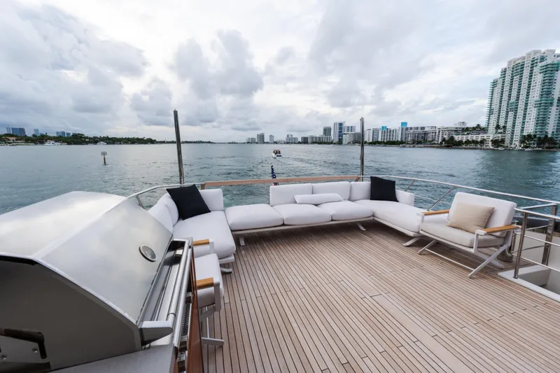 Gatsby Yacht Photos Pics Luxurious 2021 Sanlorenzo SL96 yacht deck with modern seating and scenic waterfront view.