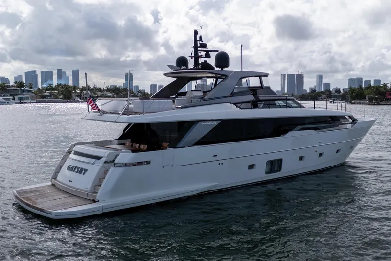 Gatsby Yacht Photos Pics 2021 Sanlorenzo SL96 yacht on water with city skyline in background.