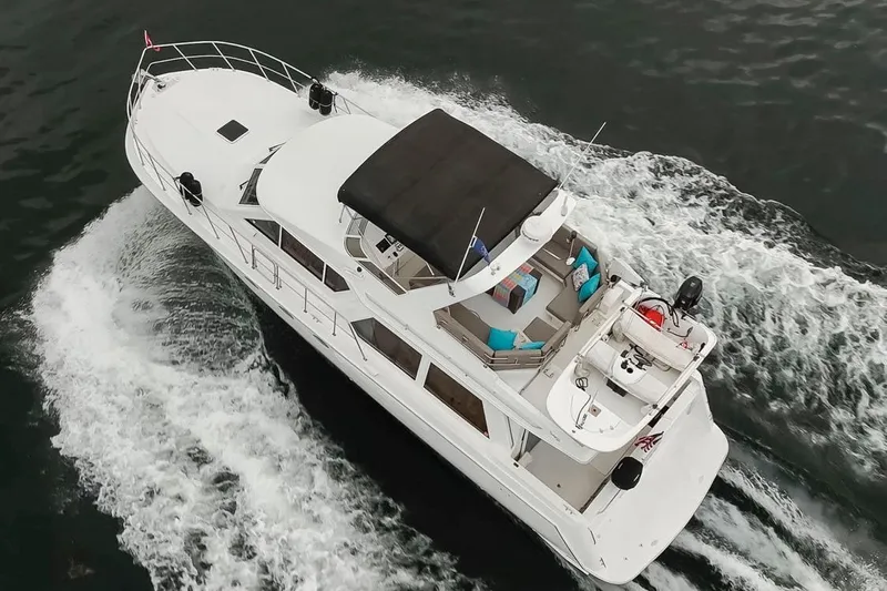 Y Knot Yacht Photos Pics Aerial view of 2003 Navigator 4800 yacht cruising on water.