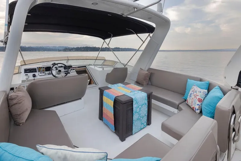 Y Knot Yacht Photos Pics Luxurious 2003 Navigator 4800 yacht interior with comfortable seating and scenic water view.