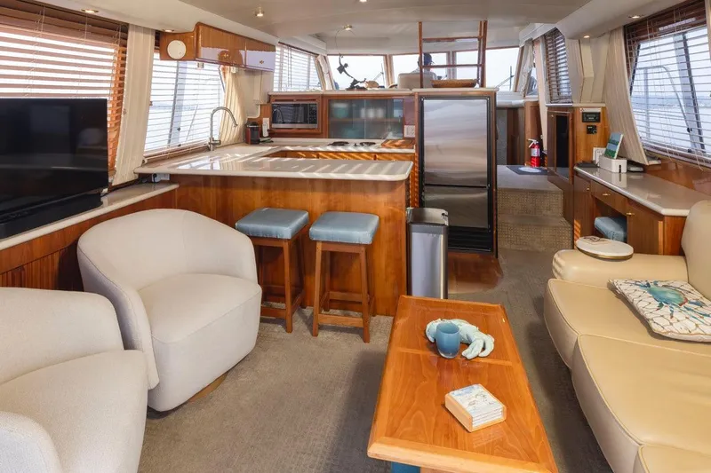 Y Knot Yacht Photos Pics Luxurious interior of 2003 Navigator 4800 yacht with modern kitchen and cozy seating area.