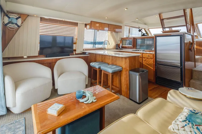 Y Knot Yacht Photos Pics Luxurious interior of 2003 Navigator 4800 yacht with modern furnishings and kitchen area.