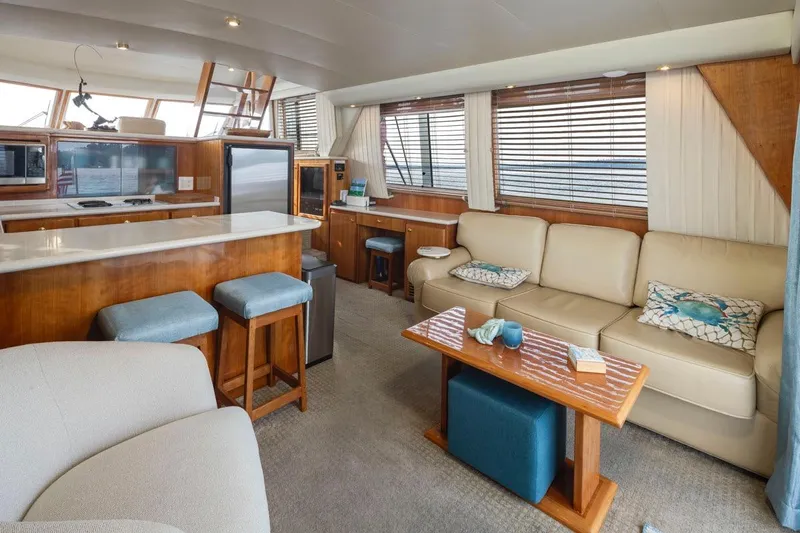 Y Knot Yacht Photos Pics Luxurious interior of 2003 Navigator 4800 yacht with modern kitchen and cozy seating area.