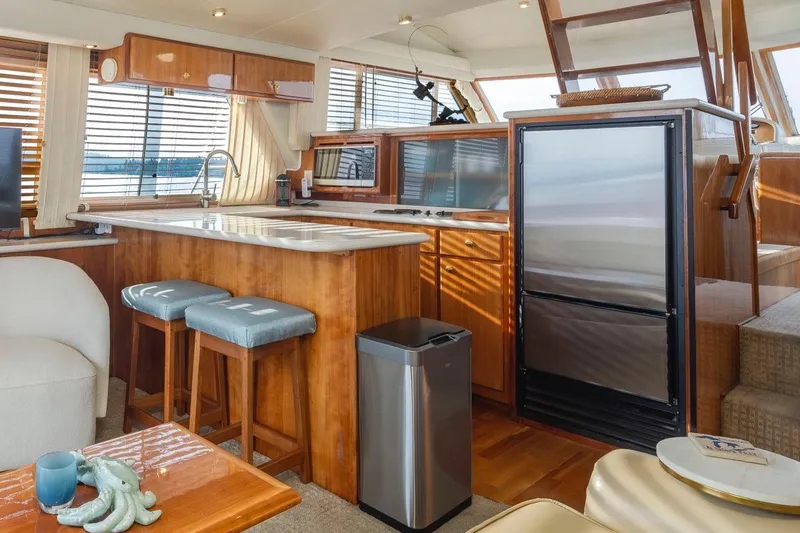 Y Knot Yacht Photos Pics Luxurious 2003 Navigator 4800 yacht interior with modern kitchen, wood finishes, and natural light.