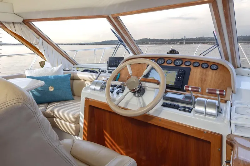 Y Knot Yacht Photos Pics Luxurious 2003 Navigator 4800 yacht helm with leather seating and advanced navigation controls.