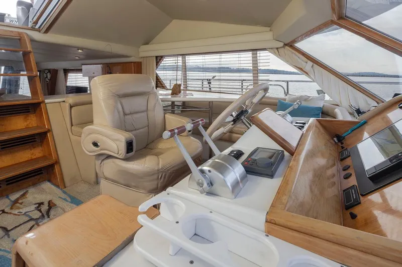 Y Knot Yacht Photos Pics Luxurious 2003 Navigator 4800 yacht interior with leather seating and modern helm controls.