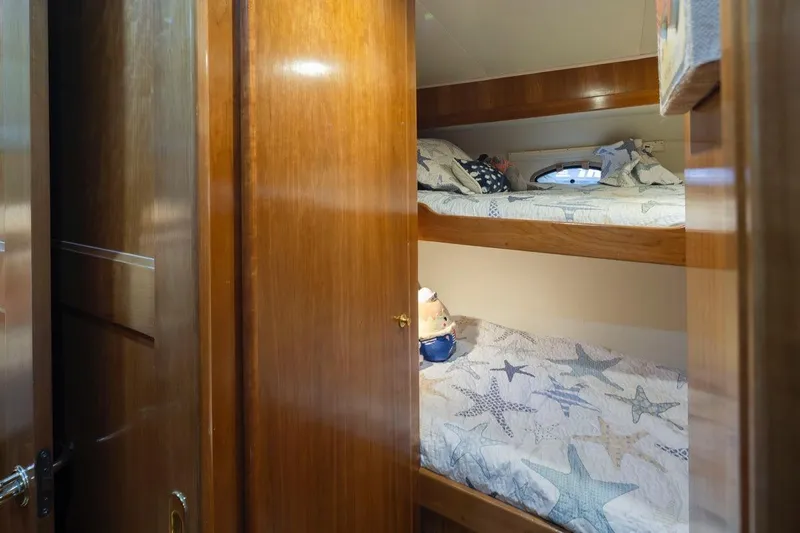 Y Knot Yacht Photos Pics Bunk beds in 2003 Navigator 4800 yacht cabin with starfish-themed bedding.