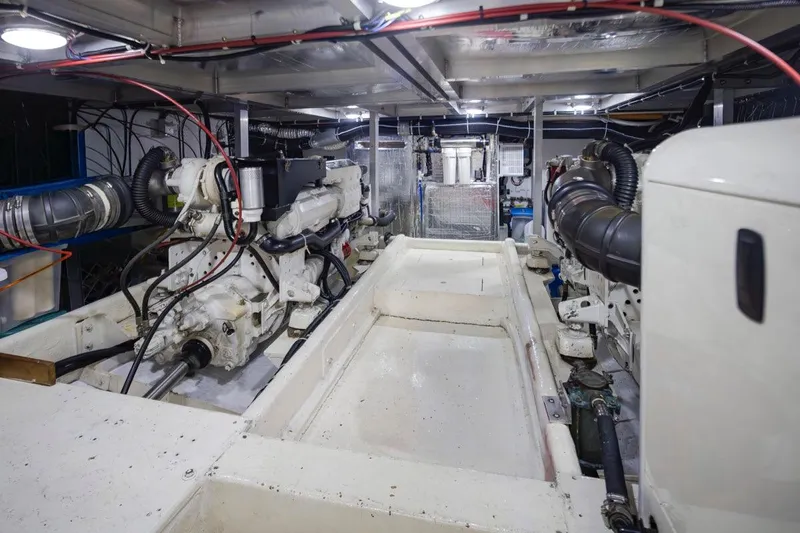 Y Knot Yacht Photos Pics Engine room of a 2003 Navigator 4800 yacht, showcasing dual engines and mechanical components.