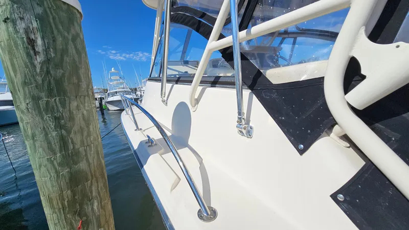  Yacht Photos Pics 2016 Grady-White Express 330 boat docked, showcasing sleek design and sturdy railings.