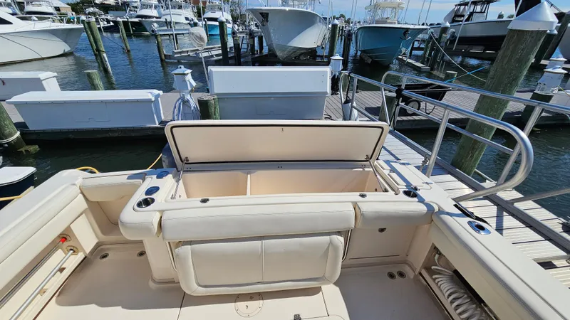  Yacht Photos Pics 2016 Grady-White Express 330 boat interior at dock, open storage compartment, marina background.
