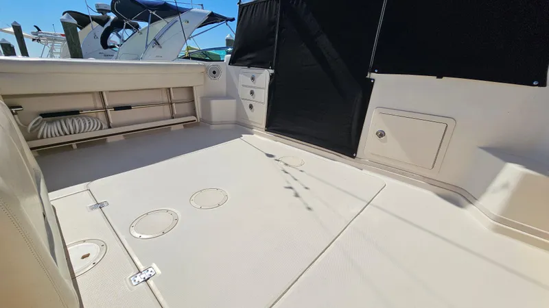  Yacht Photos Pics 2016 Grady-White Express 330 boat deck with storage compartments and seating area.