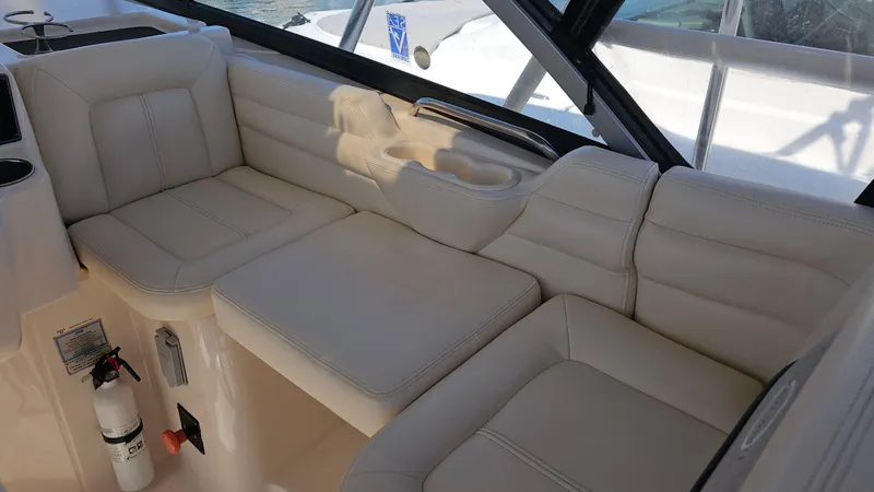  Yacht Photos Pics 2016 Grady-White Express 330 interior seating with beige upholstery and window view.