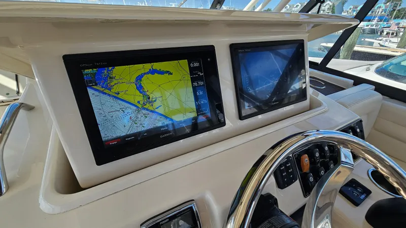  Yacht Photos Pics 2016 Grady-White Express 330 helm with navigation screens and steering wheel.