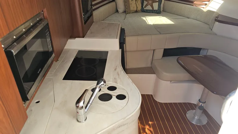  Yacht Photos Pics 2016 Grady-White Express 330 interior with kitchenette and seating area.