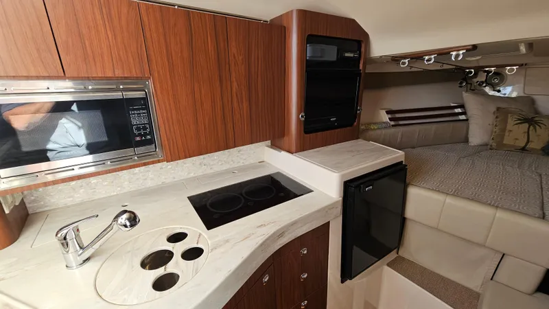  Yacht Photos Pics 2016 Grady-White Express 330 interior with kitchenette and cozy sleeping area.