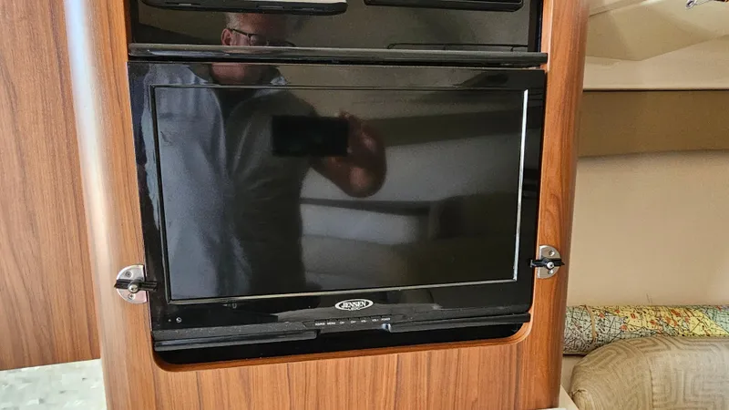  Yacht Photos Pics 2016 Grady-White Express 330 interior with mounted TV and wood paneling.