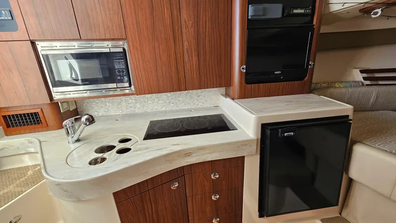  Yacht Photos Pics 2016 Grady-White Express 330 boat kitchen with microwave, stove, and fridge.