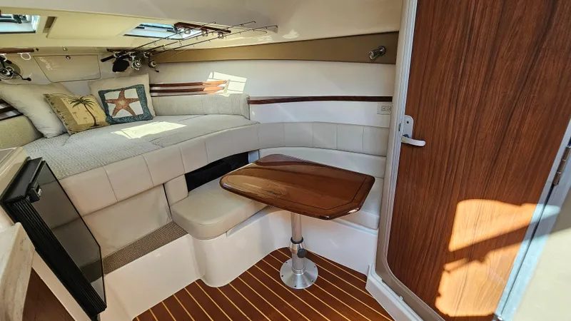  Yacht Photos Pics 2016 Grady-White Express 330 cabin interior with seating, table, and bed.
