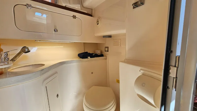 Yacht Photos Pics 2016 Grady-White Express 330 boat bathroom with sink, toilet, and storage cabinets.