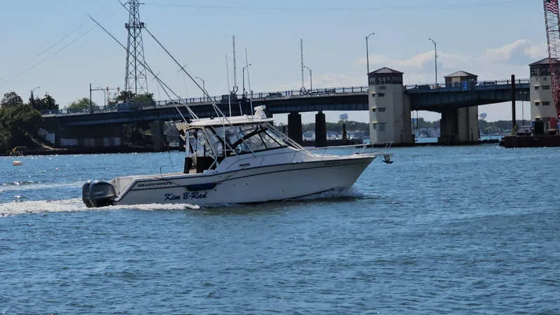  Yacht Photos Pics 2016 Grady-White Express 330 boat cruising near a bridge on a sunny day.