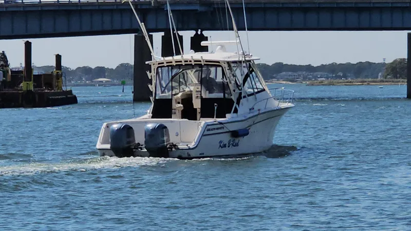  Yacht Photos Pics 2016 Grady-White Express 330 boat cruising under a bridge on a sunny day.