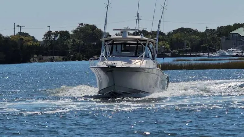  Yacht Photos Pics 2016 Grady-White Express 330 boat cruising on a sunny day in a scenic waterway.