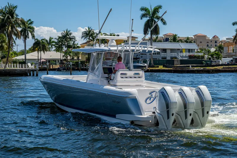  Yacht Photos Pics 2019 Intrepid 400 boat cruising on a sunny day with palm trees in the background.
