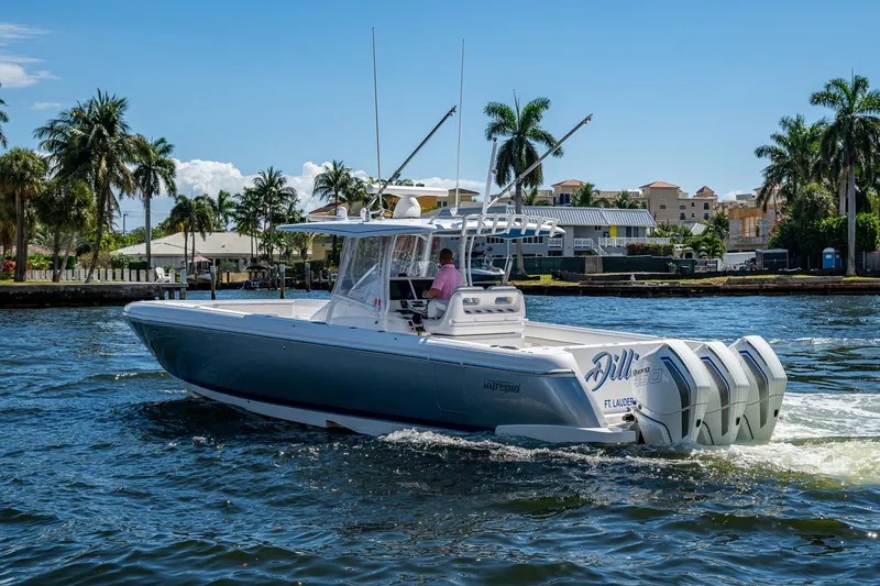  Yacht Photos Pics 2019 Intrepid 400 boat cruising on a sunny day with palm trees in the background.