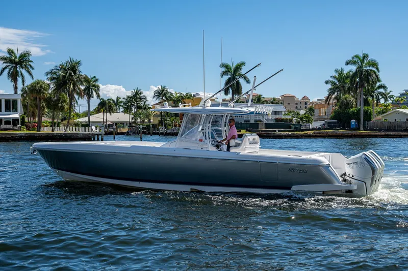  Yacht Photos Pics 2019 Intrepid 400 boat cruising on a sunny day, surrounded by palm trees and waterfront homes.
