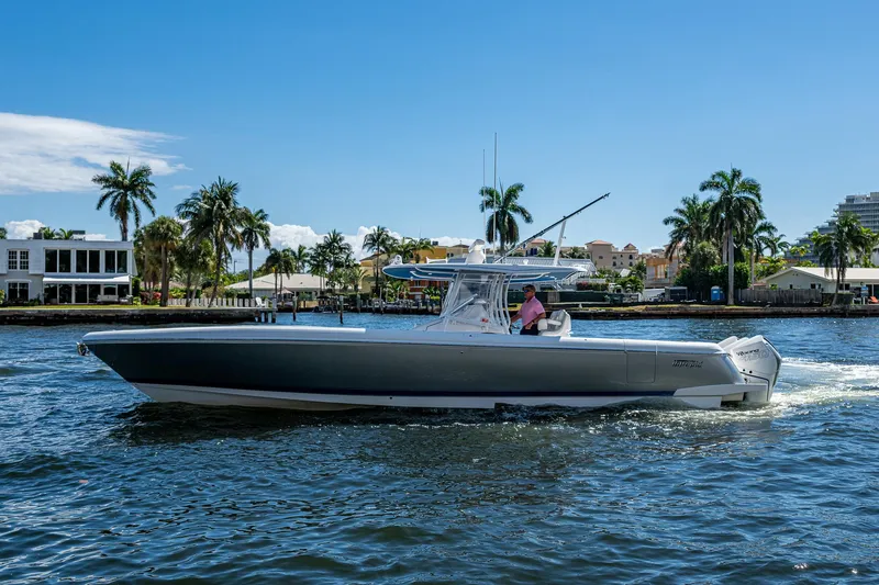  Yacht Photos Pics 2019 Intrepid 400 boat cruising on a sunny day with palm trees in the background.