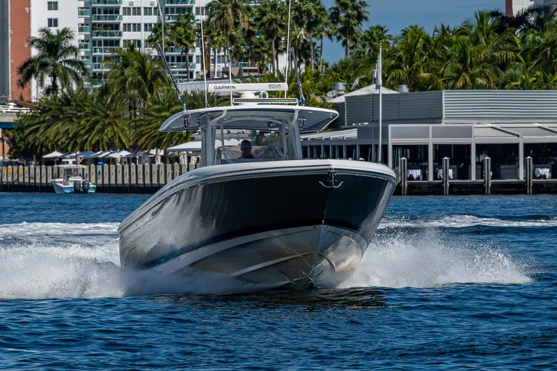  Yacht Photos Pics 2019 Intrepid 400 boat cruising on water near a city waterfront.