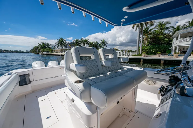  Yacht Photos Pics Luxurious 2019 Intrepid 400 boat interior with plush seating, docked by palm trees and waterfront homes.