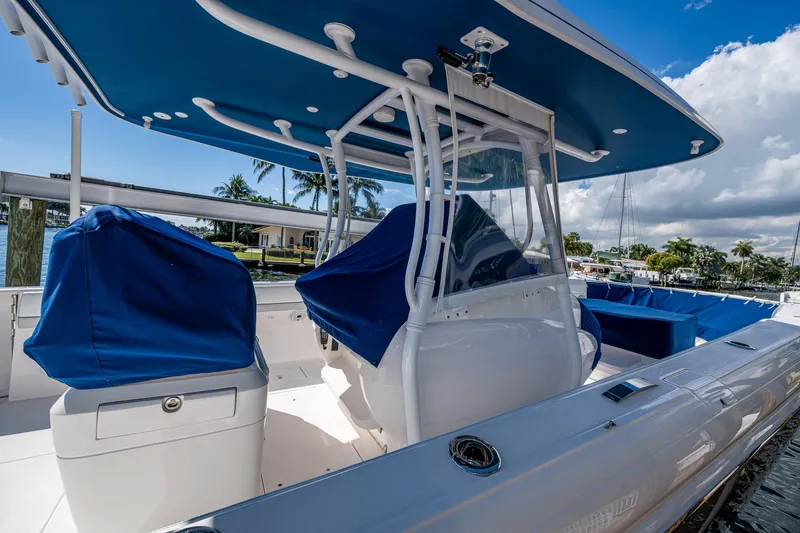  Yacht Photos Pics 2019 Intrepid 400 boat with blue covers and sleek design, docked under a sunny sky.
