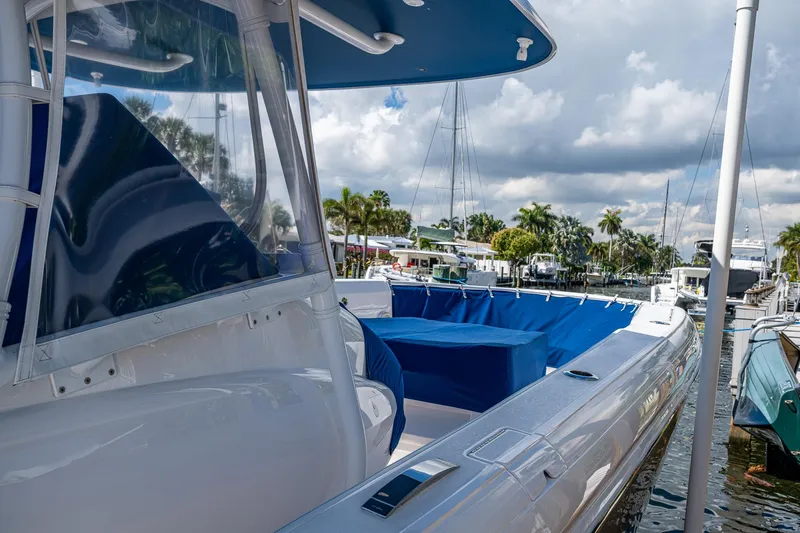  Yacht Photos Pics 2019 Intrepid 400 boat docked, featuring sleek design and blue accents under cloudy skies.