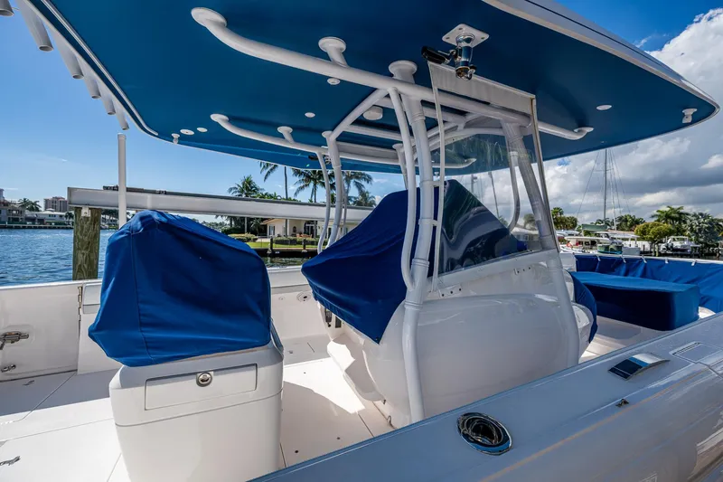  Yacht Photos Pics 2019 Intrepid 400 boat with blue covers and canopy, docked in a sunny marina.