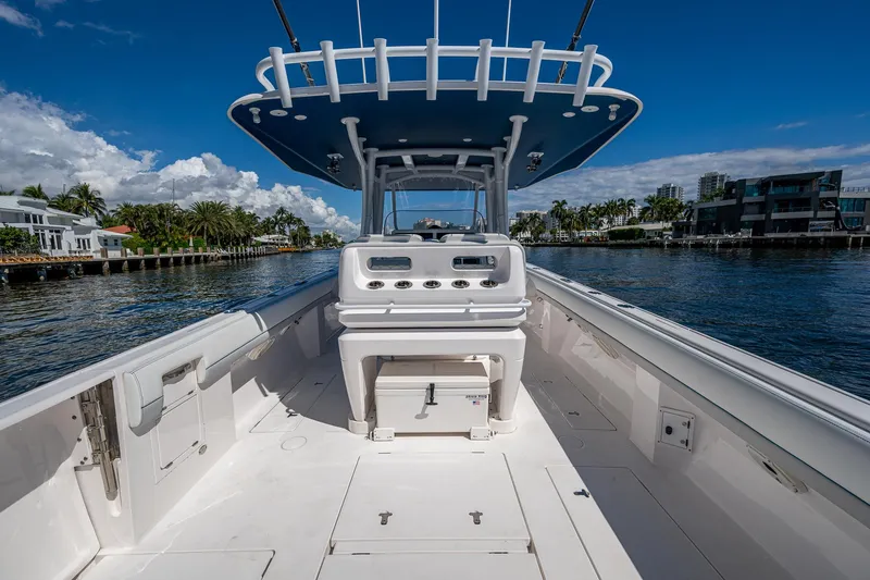 Yacht Photos Pics 2019 Intrepid 400 boat on water, clear sky, modern waterfront homes in background.