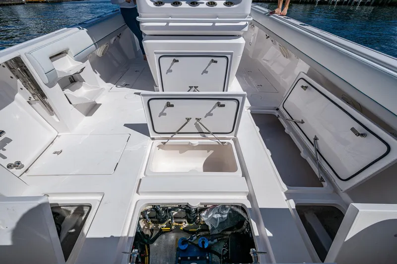  Yacht Photos Pics 2019 Intrepid 400 boat deck with open storage compartments and engine access.