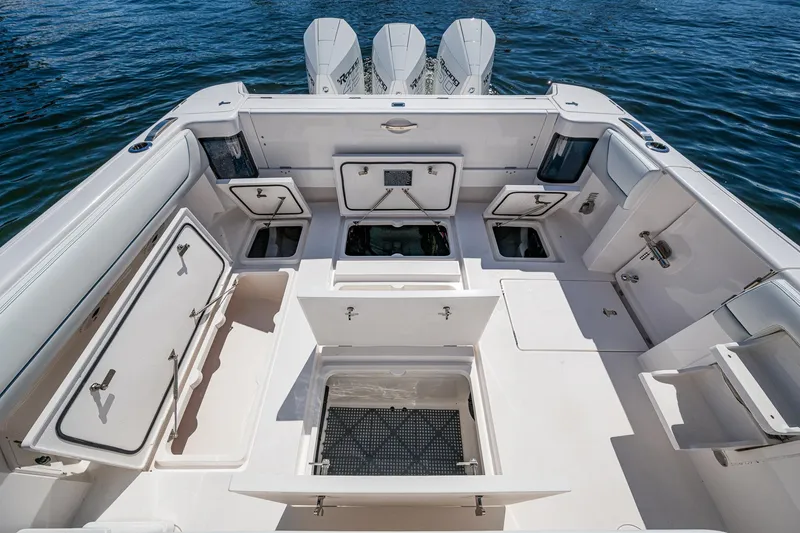  Yacht Photos Pics 2019 Intrepid 400 boat deck with storage compartments and triple outboard engines.