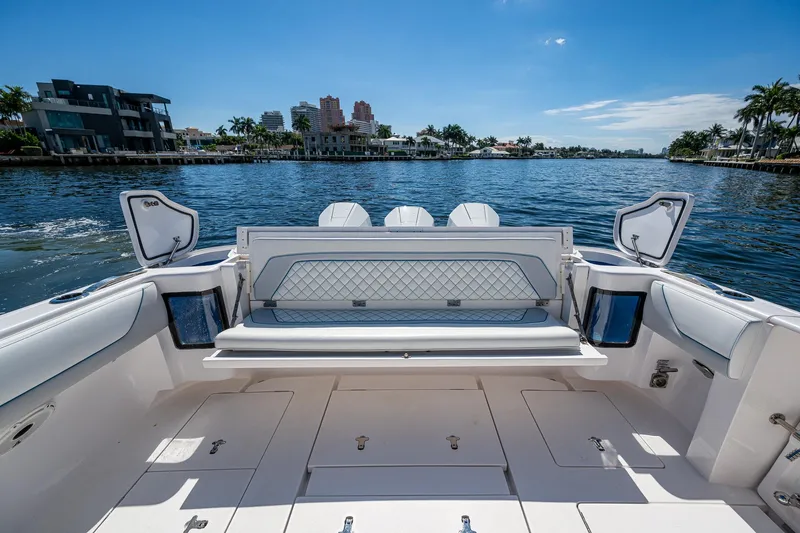  Yacht Photos Pics 2019 Intrepid 400 boat interior with waterfront view, featuring luxurious seating and storage compartments.