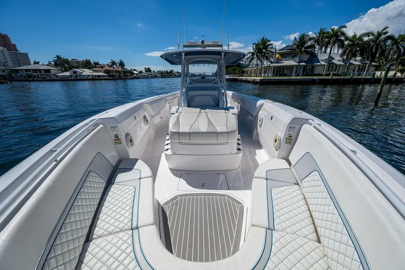  Yacht Photos Pics 2019 Intrepid 400 boat with luxurious seating on a sunny waterfront.