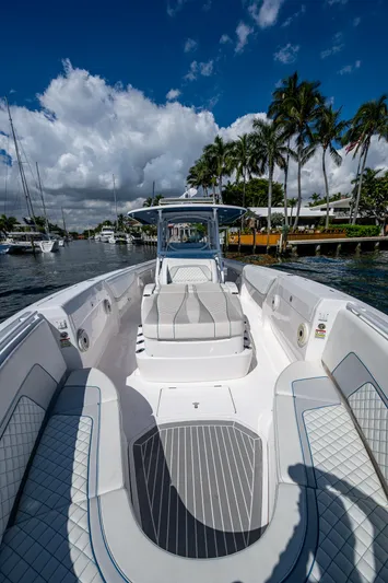  Yacht Photos Pics 2019 Intrepid 400 boat on a sunny day, docked near palm trees and waterfront homes.