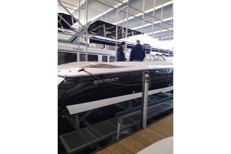  Yacht Photos Pics 2004 Cobalt 343 boat docked in a marina with two people onboard.