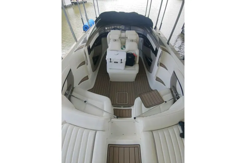  Yacht Photos Pics 2004 Cobalt 343 boat interior with white seating and wood accents, docked by the water.