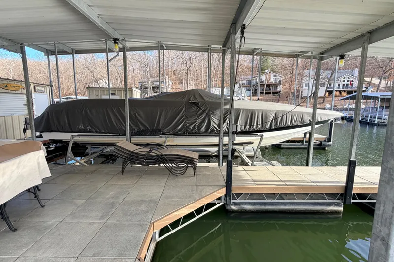  Yacht Photos Pics Covered 2004 Cobalt 343 boat docked in a marina with surrounding houses.