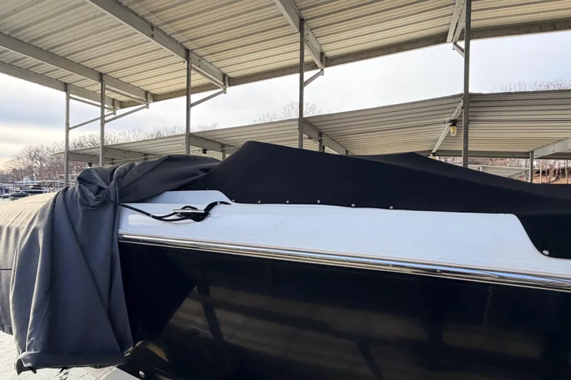  Yacht Photos Pics Covered 2004 Cobalt 343 boat under a metal canopy at a marina.