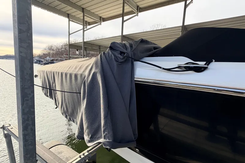  Yacht Photos Pics Covered 2004 Cobalt 343 boat docked under a metal canopy.