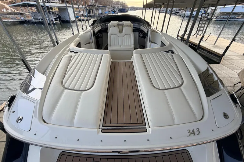  Yacht Photos Pics 2004 Cobalt 343 boat with white seating and wooden deck, docked at a marina.